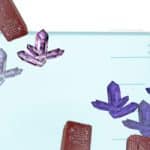 Opposite Attraction: Magnets Separate Mirror-Image Crystals